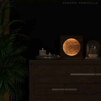 A Zengen lamp, a square wooden frame with a glowing circular wooden texture, placed on a dark wooden dresser next to a plant and a glass cloche.